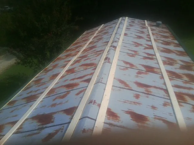 Rusted metal roof panels with new wood purlins before replacement — Storm Damage Roof Repair in Weymouth by Roofing Brothers