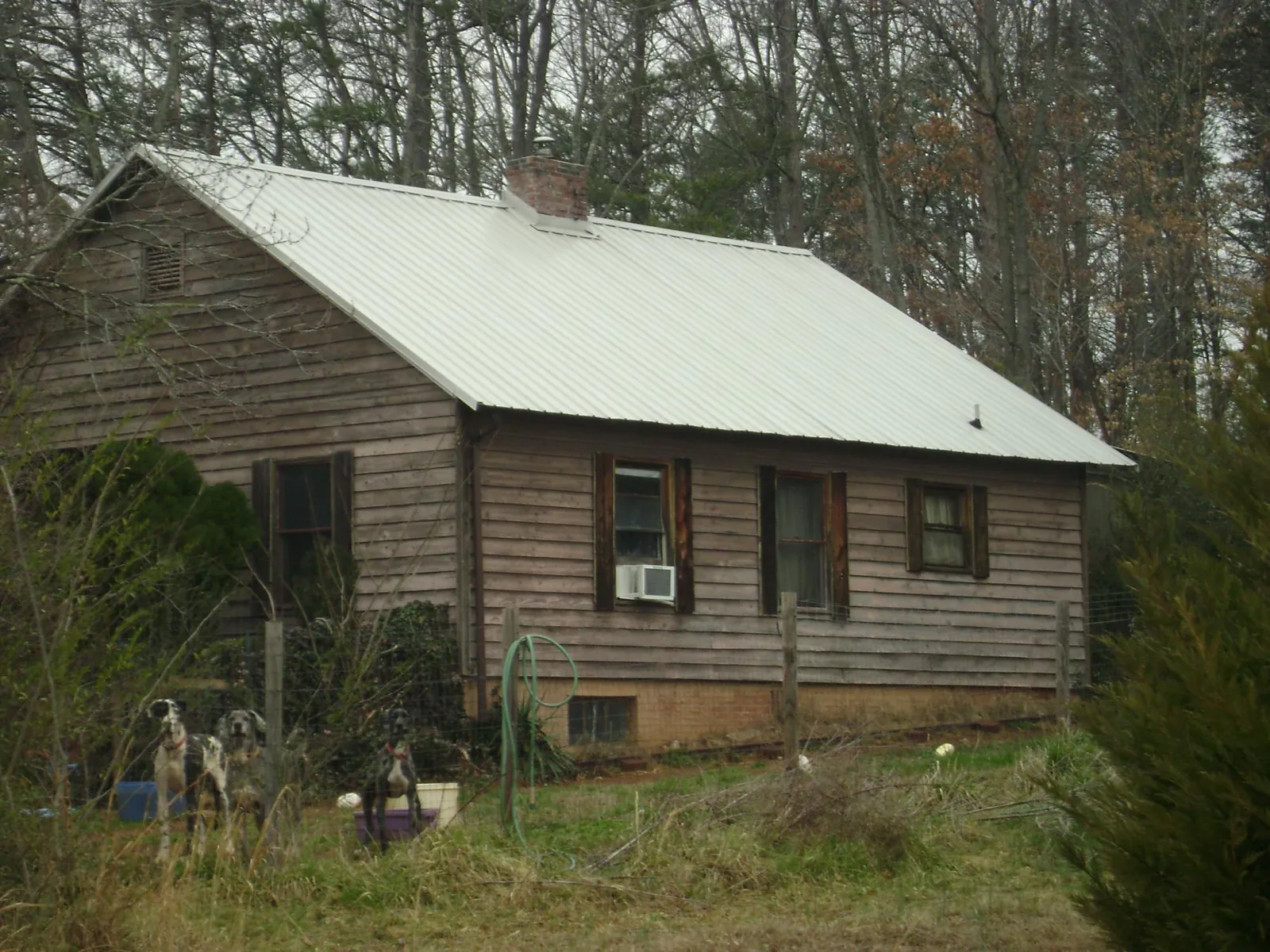 White metal roof on an old wood sided farmhouse, from a Metal Roof Installation job in Weymouth